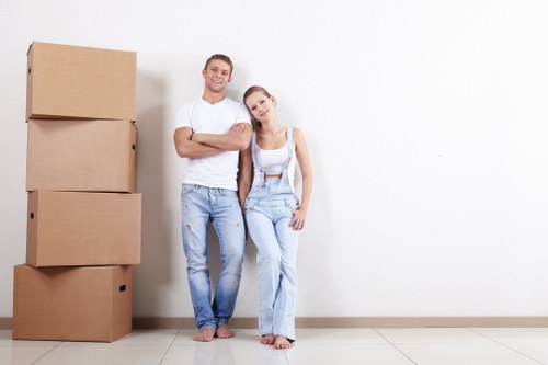 Mover loading boxes from a Holland Park apartment with clear pricing in mind