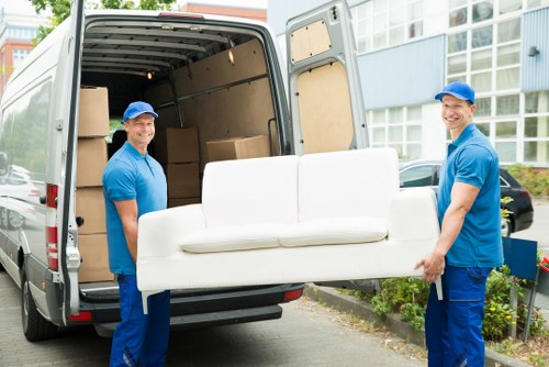 Removal team moving household furniture in Holland Park