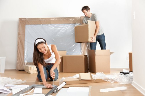 Removal team carefully packing belongings for a Holland Park home move