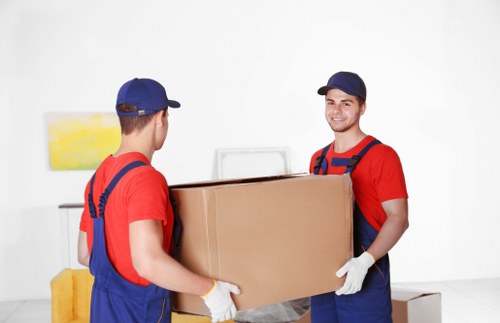 Trained movers handling items carefully in a home