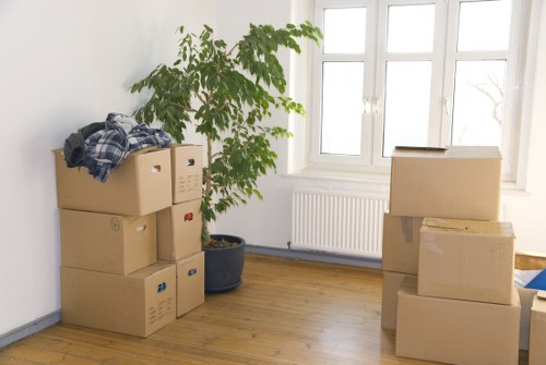 Professional movers handling belongings with care in a Holland Park property