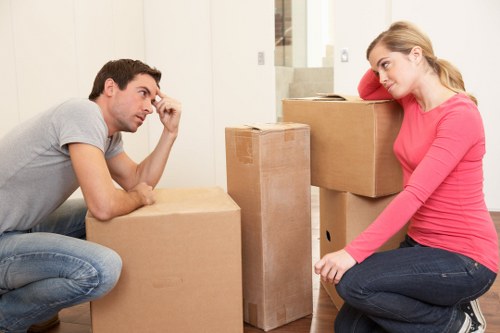 Professional movers loading a van in Holland Park