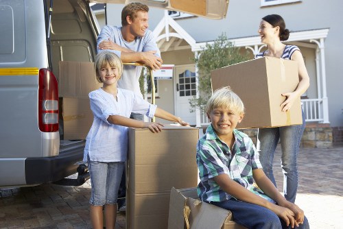 Movers wrapping fragile household items as part of packing services in Hollandpark