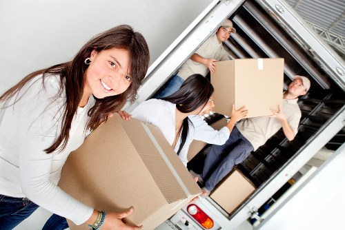 Specialist movers transporting a piano through a Hollandpark property